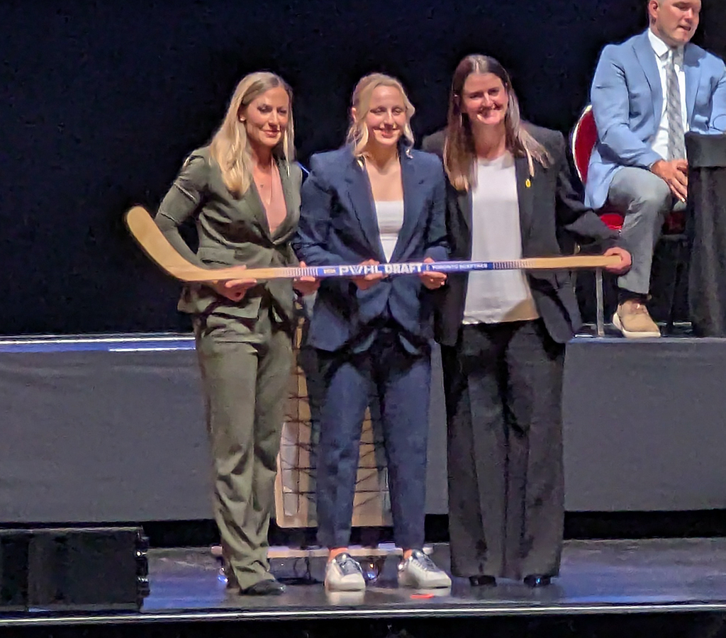 Kirsten Simms is selected eighth overall at the 2026 PWHL Entry Draft, flanked by PWHL senior vice president Jayna Hefford and Toronto Sceptres general manager Gina Kingsbury.
