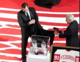 Sergei Fedorov and Mickey Redmond unveil a commemorative pair of Fedorov's signature white skates during Fedorov's jersey retirement ceremony.
