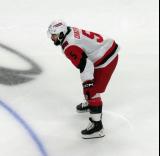 Jalen Chatfield of the Carolina Hurricanes gets set for a faceoff during a game against the Detroit Red Wings.