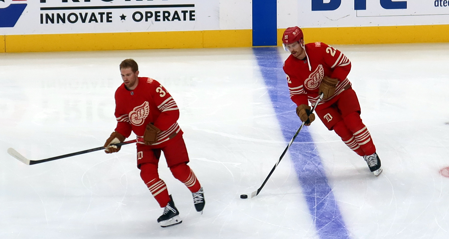 J.T. Compher and Mason Appleton of the Detroit Red Wings skate at the blue line during pre-game warmups before a game against the Montreal Canadiens.
